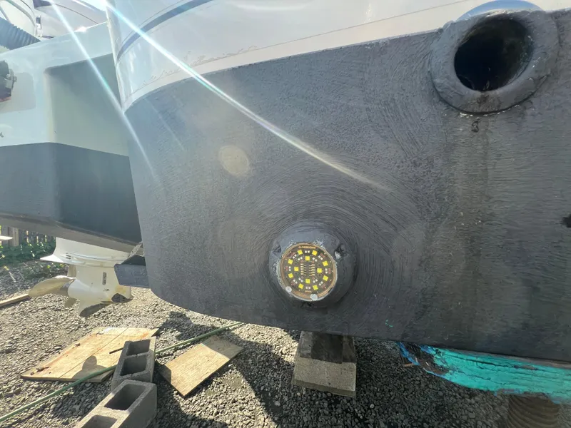Slide: The Image of 2019 Regulator 41 boat hull with underwater light, dry docked on blocks. - 18