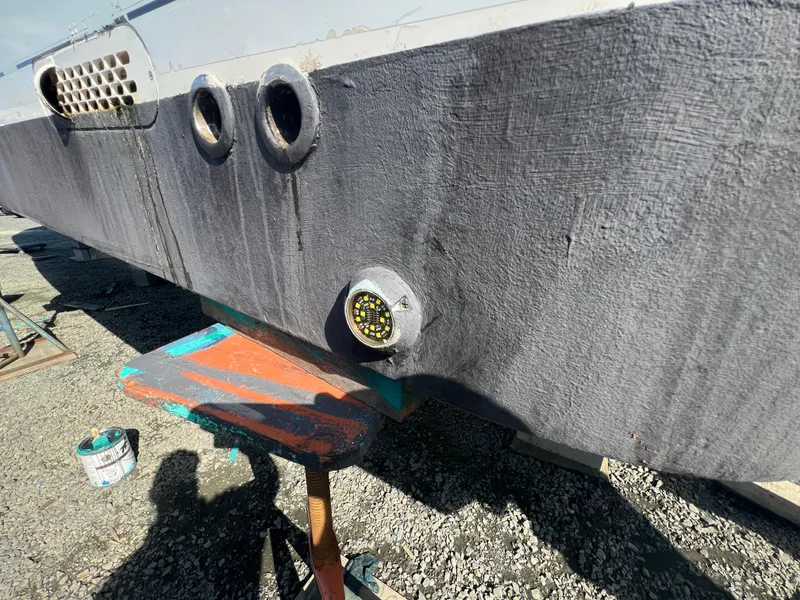 Slide: The Image of 2019 Regulator 41 boat hull with visible wear and maintenance equipment. - 20