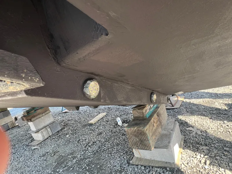 Slide: The Image of Close-up of 2019 Regulator 41 boat hull on blocks, showing structural details. - 21