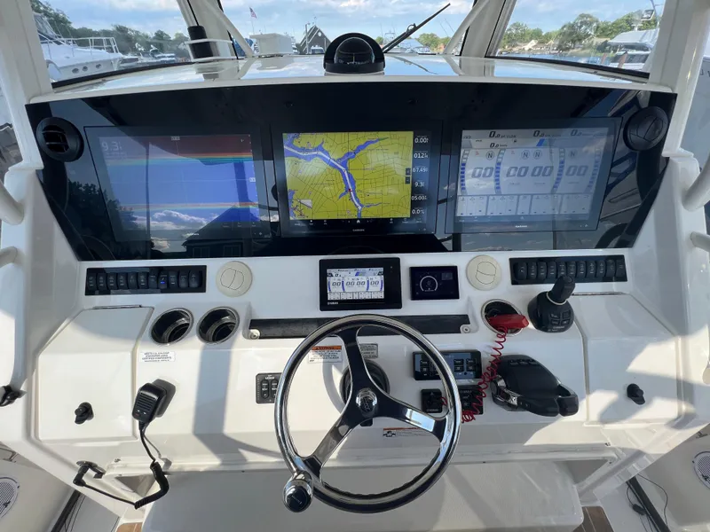 Slide: The Image of 2019 Regulator 41 boat dashboard with navigation screens and controls. - 26