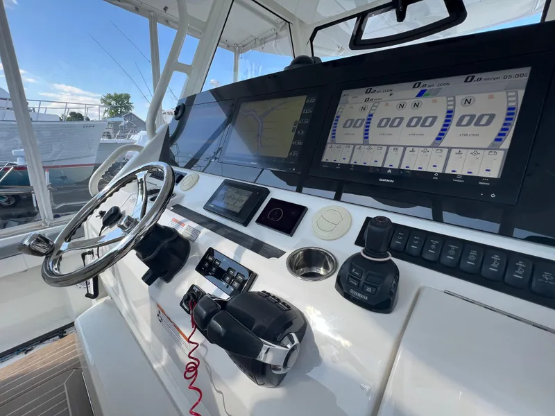 Slide: The Image of 2019 Regulator 41 boat helm with advanced navigation and control systems. - 30