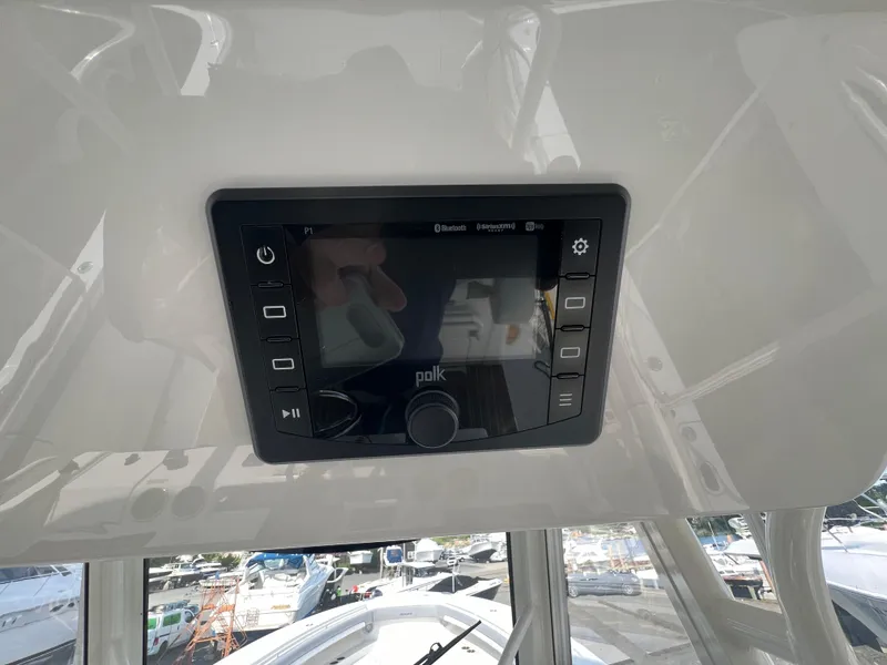 Slide: The Image of 2019 Regulator 41 boat dashboard with Polk audio system display. - 37