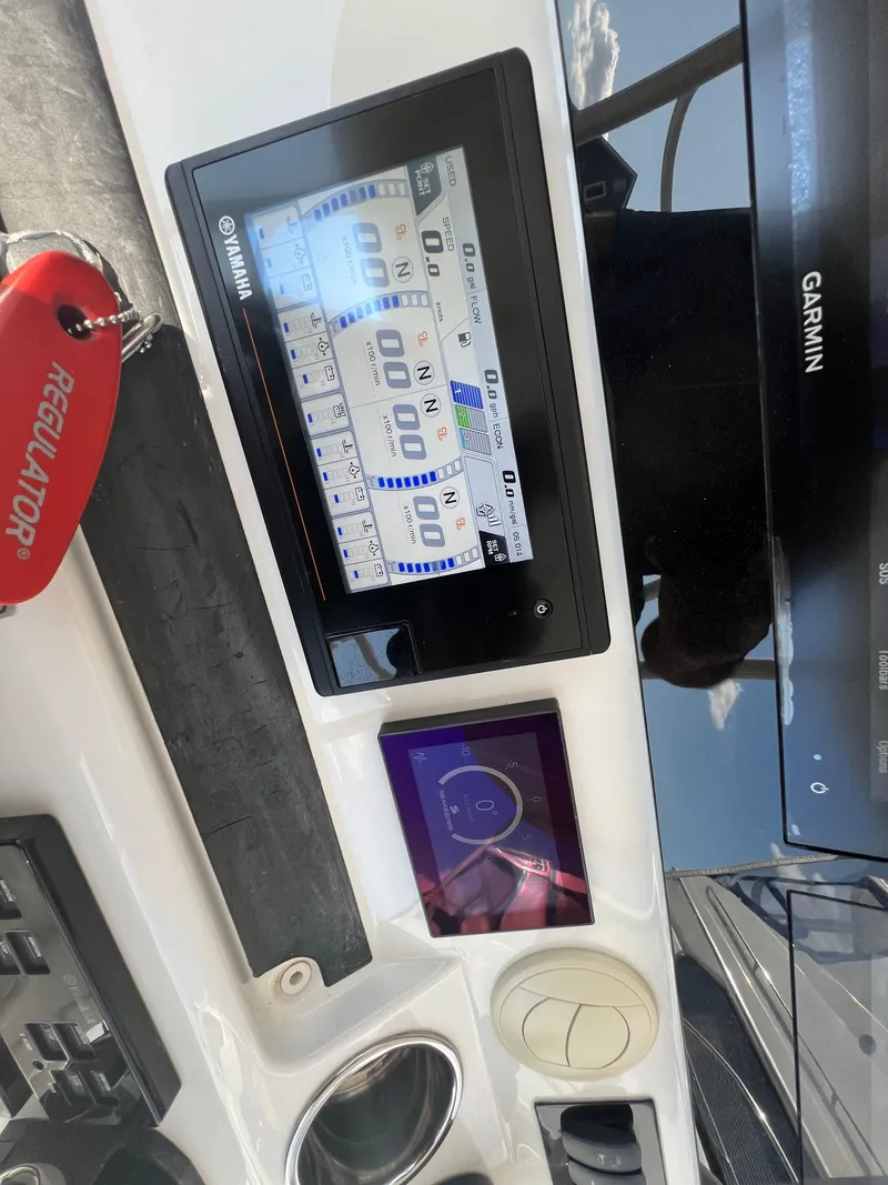Slide: The Image of 2019 Regulator 41 boat dashboard with Garmin and Yamaha displays. - 39