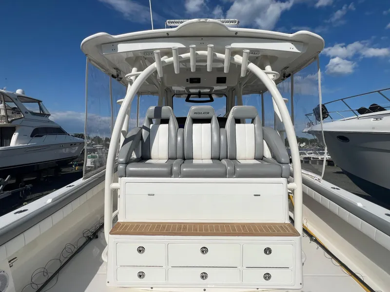 Slide: The Image of 2019 Regulator 41 boat with seating and storage, docked under a clear blue sky. - 42