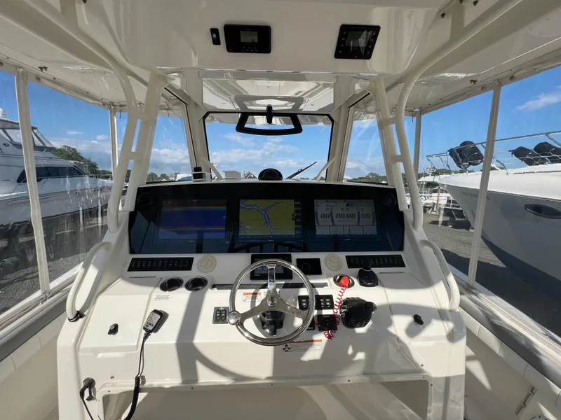 Slide: The Image of 2019 Regulator 41 boat cockpit with advanced navigation system and steering wheel. - 43