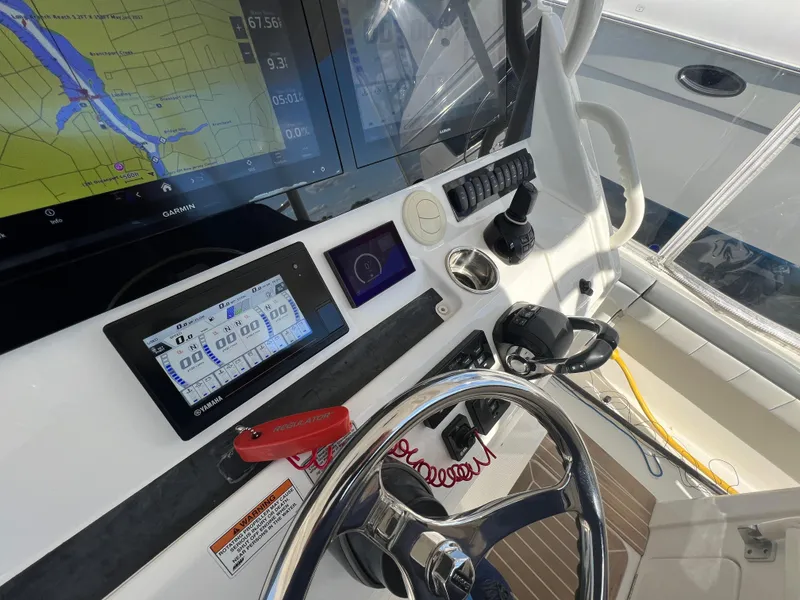 Slide: The Image of 2019 Regulator 41 boat helm with navigation screens and steering wheel. - 44