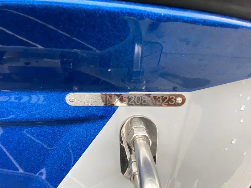 Slide: The Image of 2023 Supreme S240 boat hull with identification number, blue and white design. - 13