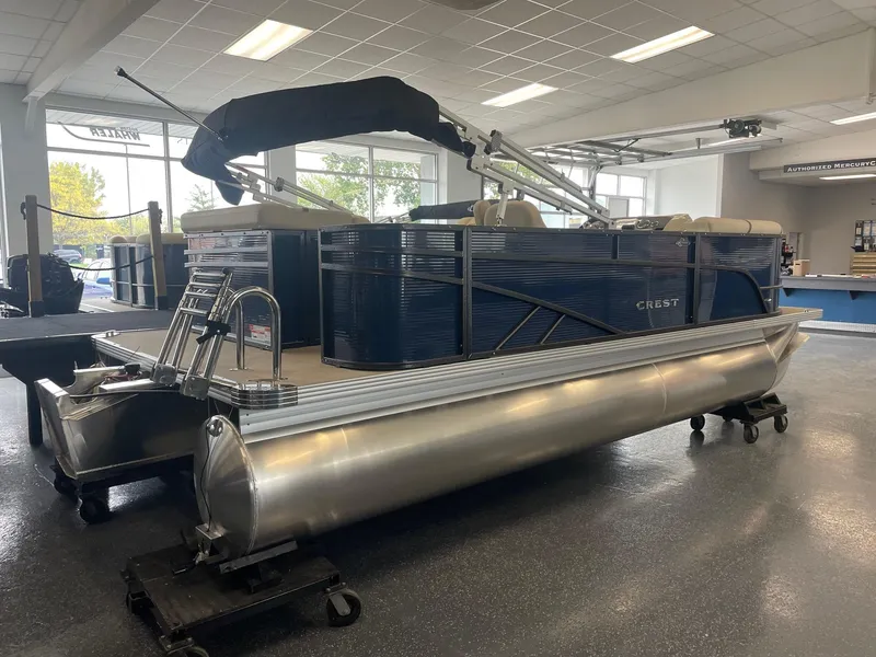 Slide: The Image of 2024 Crest 200L Classic LX pontoon boat in showroom, featuring sleek design and modern amenities. - 3