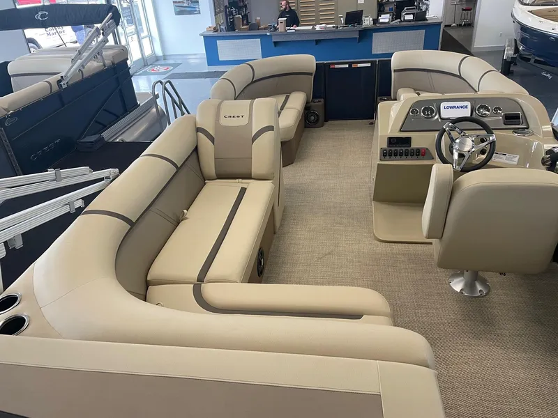 Slide: The Image of 2024 Crest 200L Classic LX pontoon boat interior with beige seating and modern dashboard. - 4