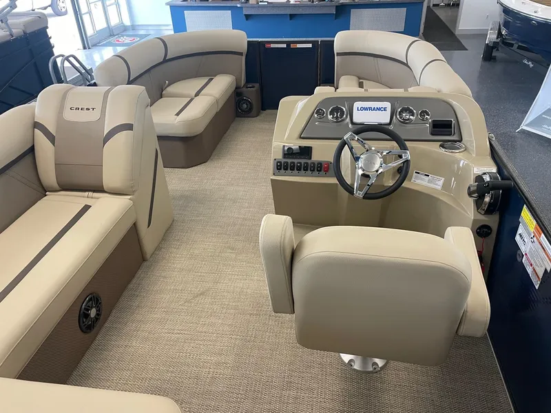 Slide: The Image of 2024 Crest 200L Classic LX boat interior with beige seating and modern dashboard. - 6
