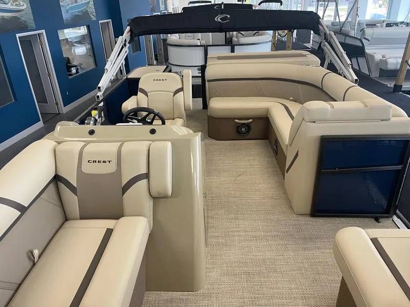 Slide: The Image of 2024 Crest 200L Classic LX pontoon boat interior with beige seating and modern design. - 8