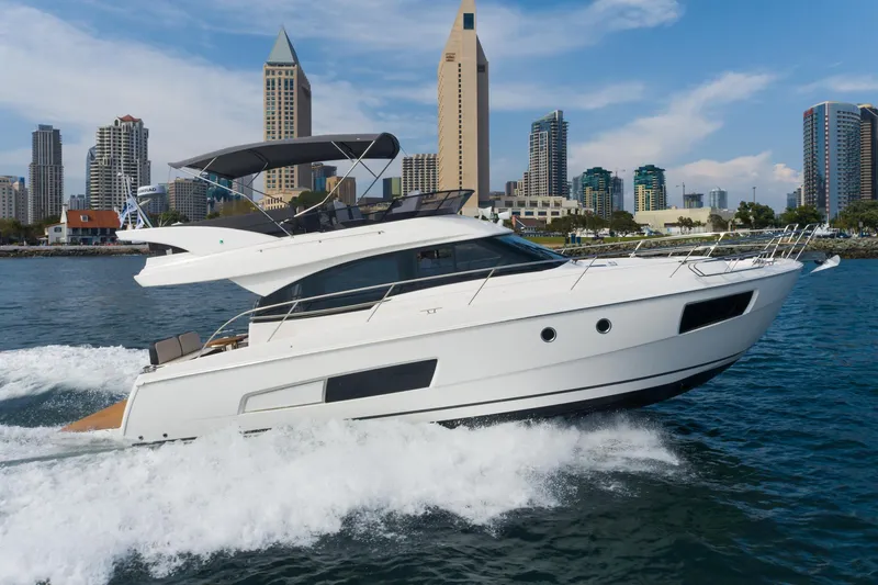 Slide: The Image of 2025 Bavaria Virtess 420 Fly yacht cruising near city skyline. - 0