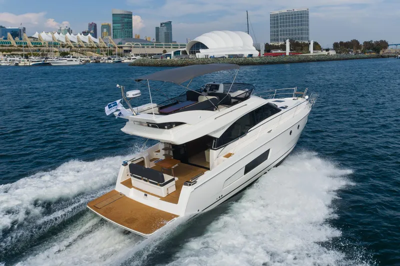 Slide: The Image of 2025 Bavaria Virtess 420 Fly yacht cruising near a city waterfront. - 17
