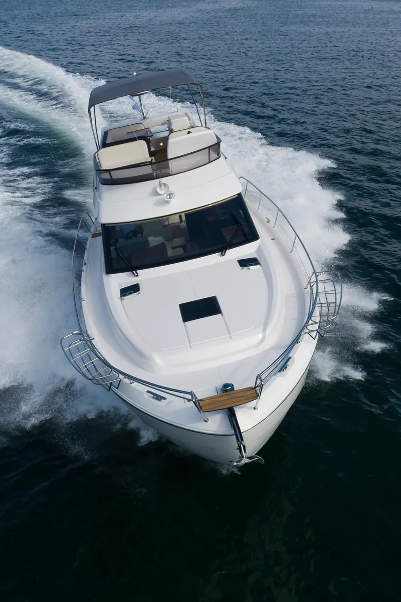 Slide: The Image of 2025 Bavaria Virtess 420 Fly yacht cruising on open water. - 19