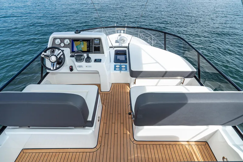 Slide: The Image of Flybridge of 2025 Bavaria Virtess 420 Fly yacht with modern controls and seating. - 25