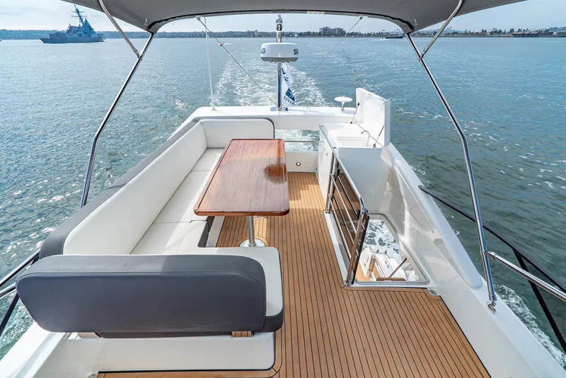 Slide: The Image of Luxurious Bavaria Virtess 420 Fly yacht deck with seating and table, cruising on open water. - 28