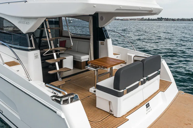 Slide: The Image of 2025 Bavaria Virtess 420 Fly yacht, elegant deck with seating and table, ocean backdrop. - 32