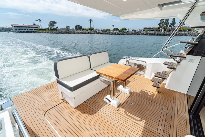 Slide: The Image of Luxurious Bavaria Virtess 420 Fly yacht deck with seating and table, cruising on calm waters. - 35