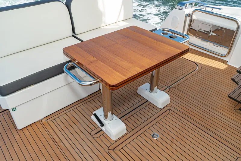 Slide: The Image of Luxury Bavaria Virtess 420 Fly 2025 yacht deck with wooden table and seating. - 39