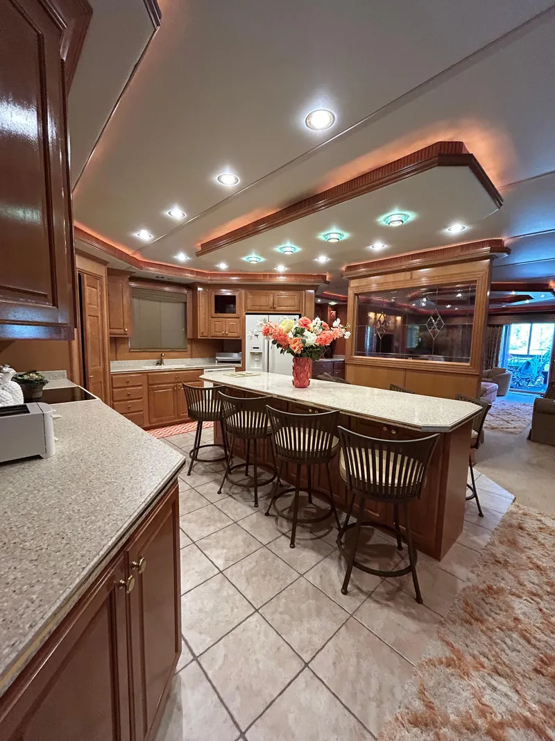 Slide: The Image of Luxurious 2004 Fantasy houseboat kitchen with island, bar stools, and elegant lighting. - 11