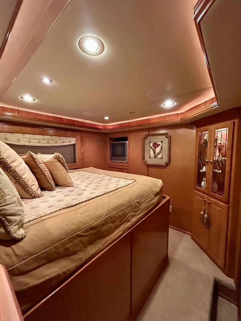 Slide: The Image of Luxurious bedroom interior in a 2004 Fantasy houseboat, featuring elegant lighting and cozy bedding. - 13