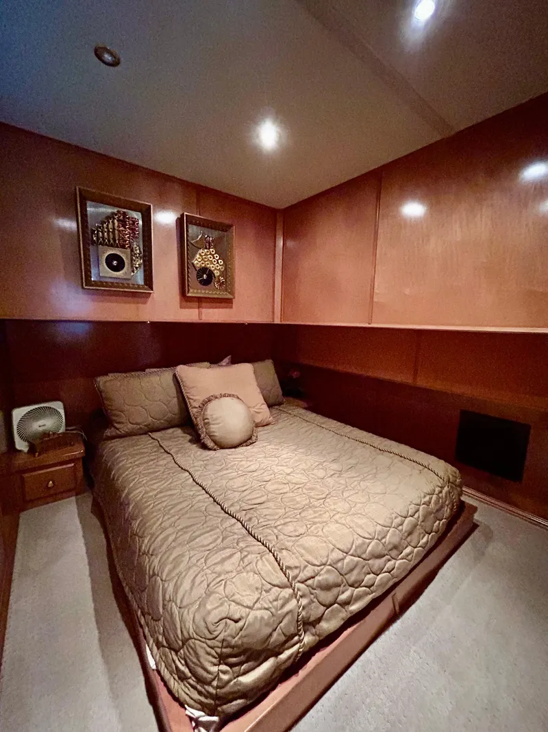 Slide: The Image of Cozy bedroom in a 2004 Fantasy houseboat with elegant wood paneling and decorative artwork. - 20