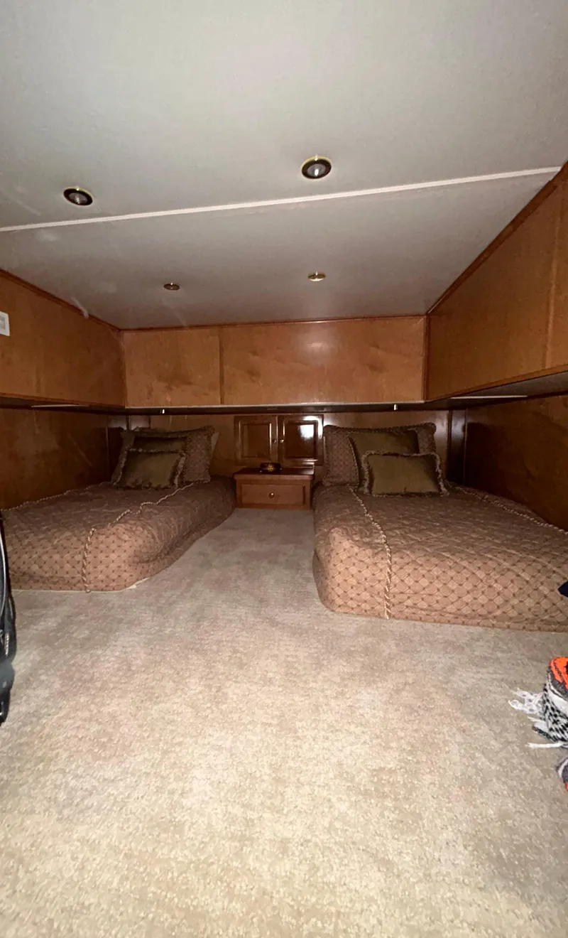 Slide: The Image of Cozy twin beds in a 2004 Fantasy houseboat cabin with wood paneling. - 22