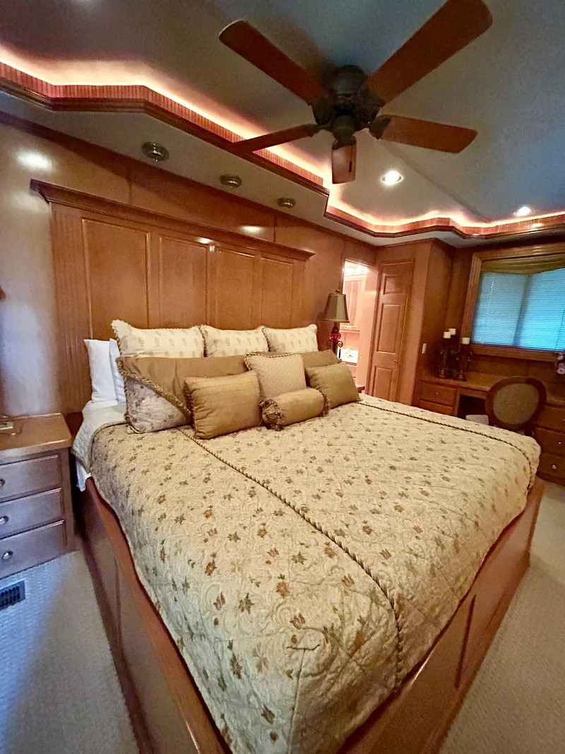 Slide: The Image of Luxurious bedroom in a 2004 Fantasy houseboat with elegant wood paneling and cozy bedding. - 25