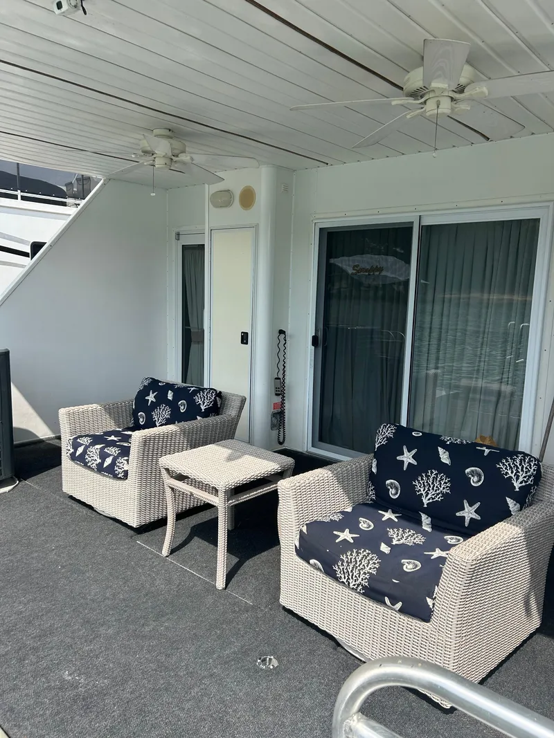 Slide: The Image of Cozy houseboat deck with wicker chairs and nautical-themed cushions, Fantasy model, 2004. - 30