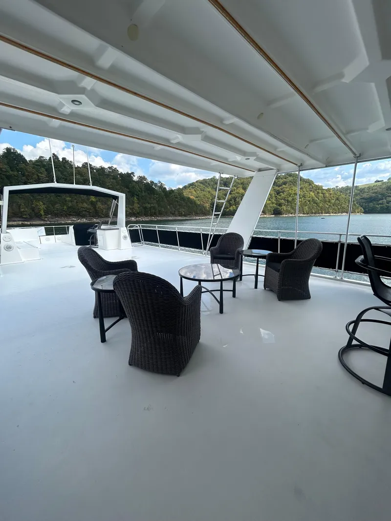 Slide: The Image of Spacious deck of 2004 Fantasy houseboat with wicker chairs, scenic lake view. - 35