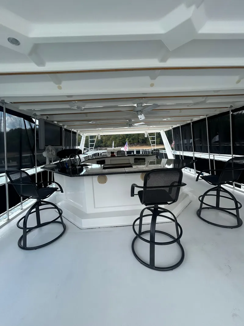 Slide: The Image of Spacious 2004 Fantasy houseboat interior with bar stools and panoramic windows. - 36