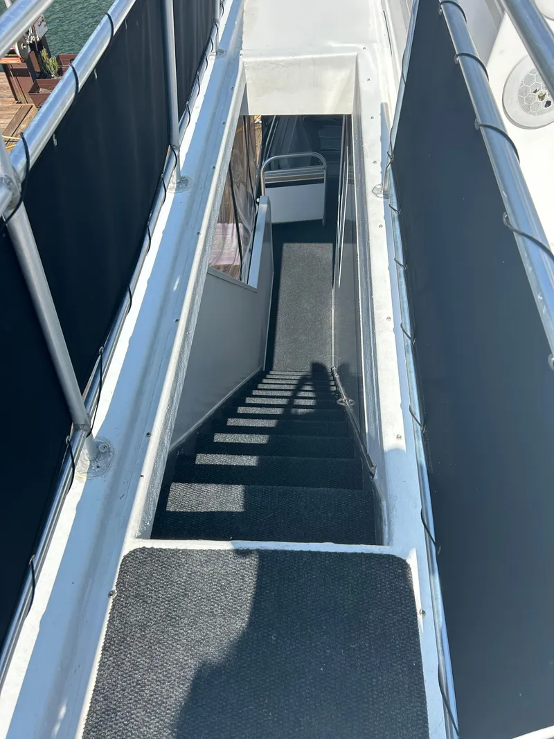 Slide: The Image of Staircase on a 2004 Fantasy Houseboat, featuring sleek railings and carpeted steps. - 38