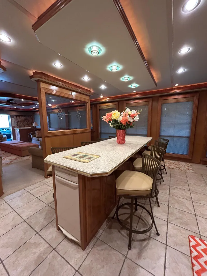 Slide: The Image of Luxurious 2004 Fantasy houseboat interior with elegant kitchen island and stylish seating. - 9