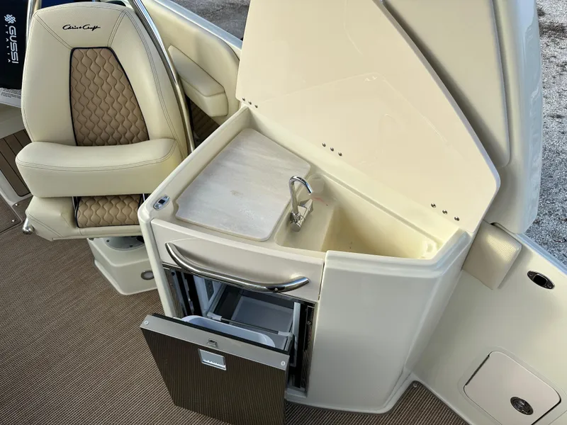Slide: The Image of 2025 Chris-Craft Launch 28 GT interior with luxurious seating and built-in sink. - 12