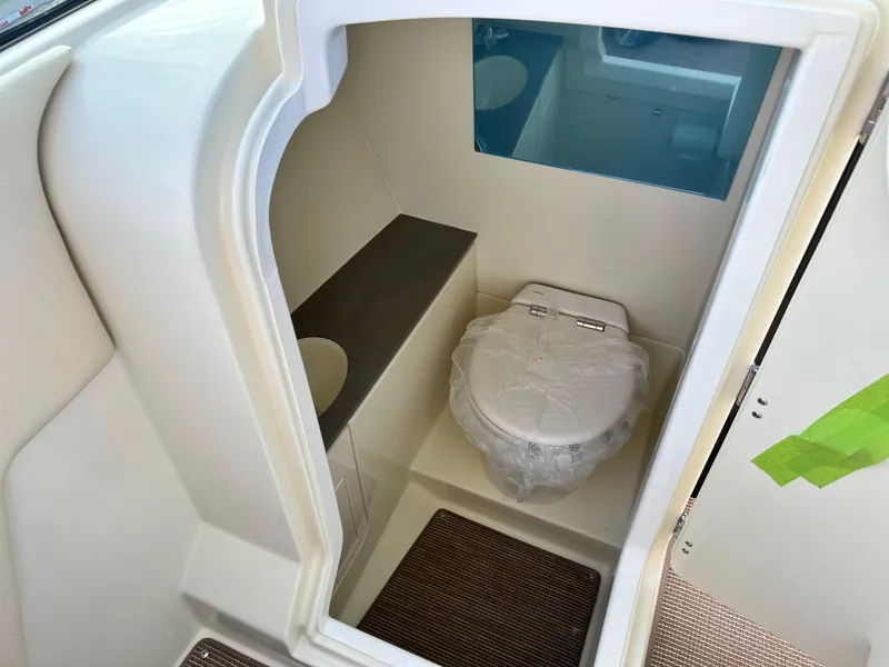 Slide: The Image of 2025 Chris-Craft Launch 28 GT boat interior with compact bathroom and toilet. - 17
