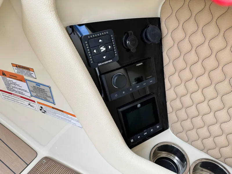 Slide: The Image of Control panel of 2025 Chris-Craft Launch 28 GT with quilted upholstery and cup holders. - 20