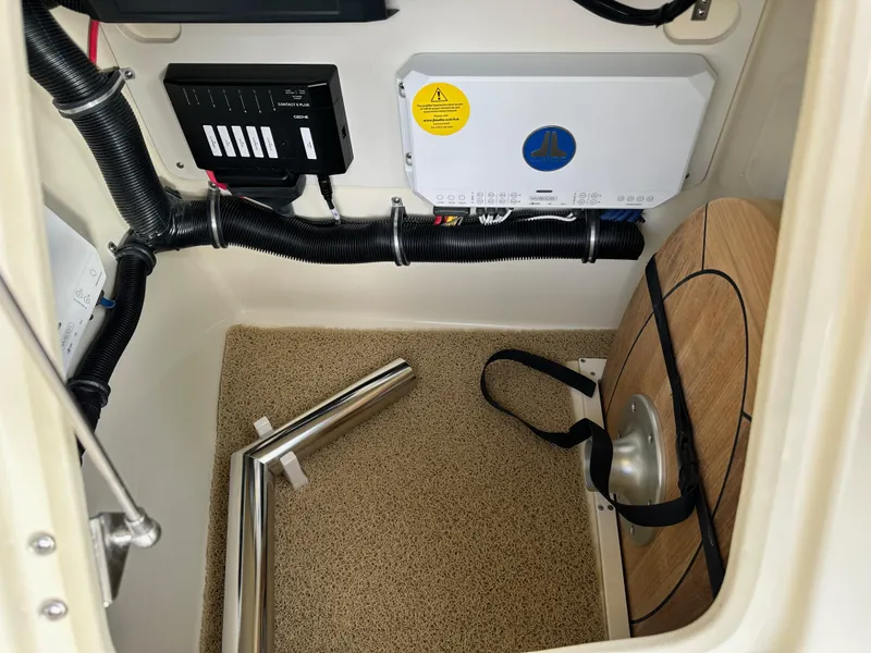 Slide: The Image of 2025 Chris-Craft Launch 28 GT interior storage compartment with equipment and wiring. - 24