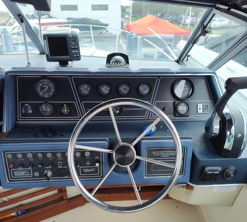 Slide: The Image of Dashboard of a 1988 Sea Ray 268 DA boat with steering wheel and gauges. - 3