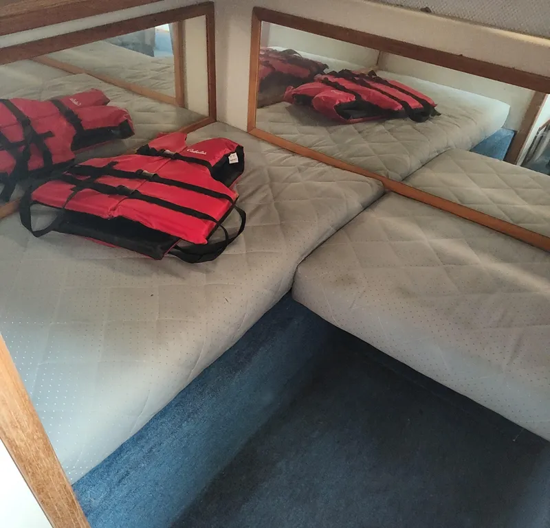 Slide: The Image of Interior cabin of 1988 Sea Ray 268 DA with life jackets on bed. - 5
