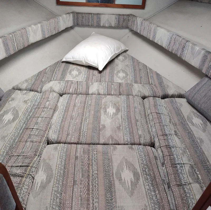 Slide: The Image of Interior cabin of 1988 Sea Ray 268 DA with patterned cushions and a pillow. - 6