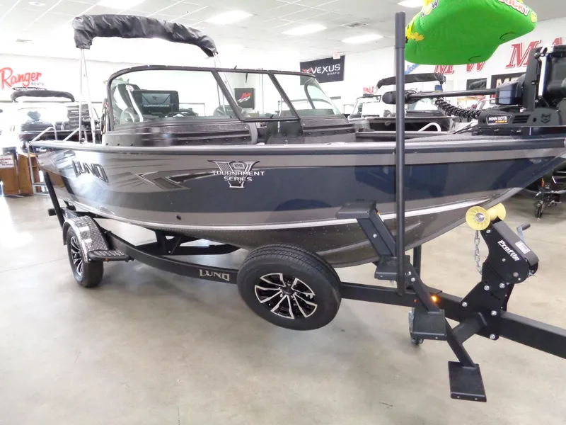 Slide: The Image of 2025 Lund 1875 Pro-V Sport boat on trailer in showroom. - 2