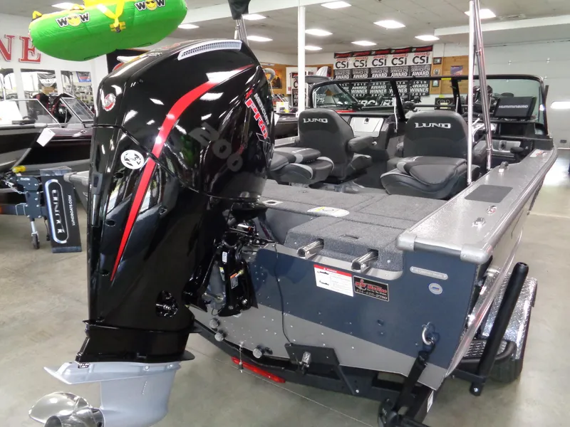 Slide: The Image of 2025 Lund 1875 Pro-V Sport boat with powerful outboard motor in showroom. - 4