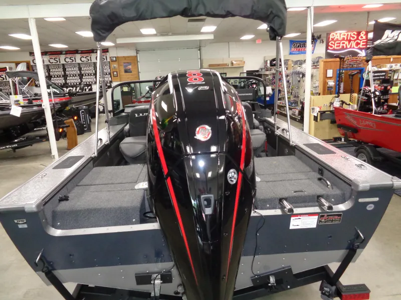 Slide: The Image of 2025 Lund 1875 Pro-V Sport boat with powerful engine in showroom. - 5