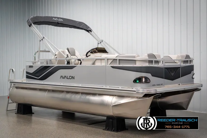Slide: The Image of 2025 Avalon VEN RF pontoon boat in showroom, featuring sleek design and modern amenities. - 2