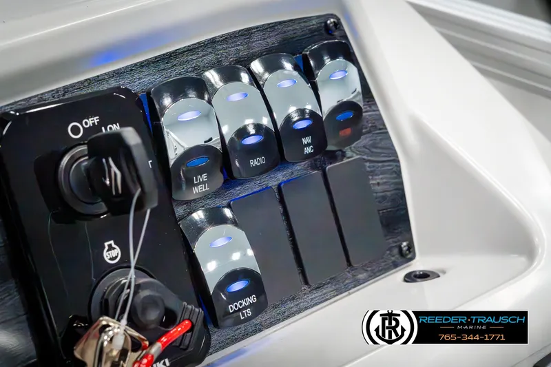 Slide: The Image of Control panel of 2025 Avalon VEN RF boat with illuminated switches and ignition keys. - 35
