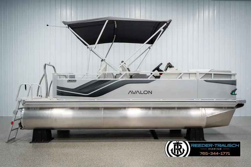 Slide: The Image of 2025 Avalon VEN RF pontoon boat with canopy, displayed indoors at Reeder Trausch Marine. - 5
