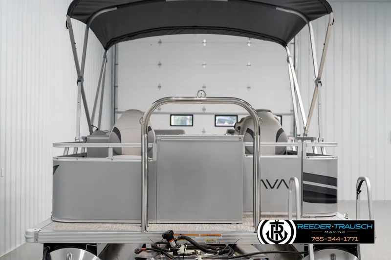 Slide: The Image of 2025 Avalon VEN RF pontoon boat in a showroom with canopy and seating. - 7