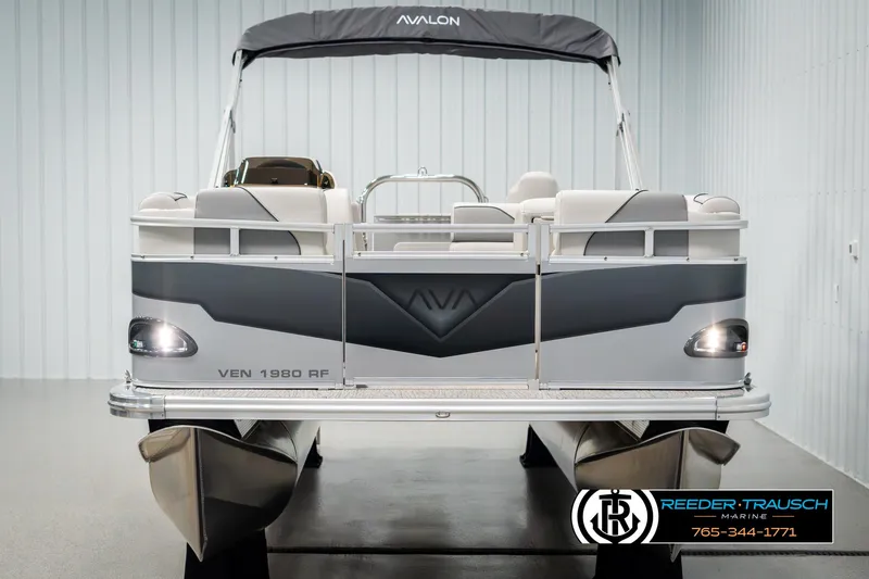 Slide: The Image of Avalon VEN RF 2025 pontoon boat displayed in showroom with Reeder-Trausch Marine logo. - 8