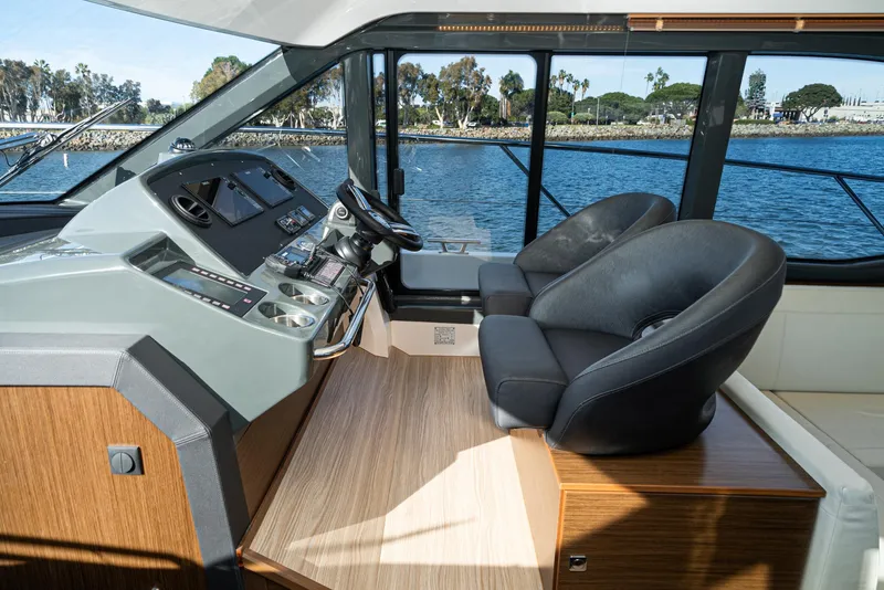 Slide: The Image of 2024 Bavaria R40 yacht cockpit with modern controls and plush seating by the water. - 49
