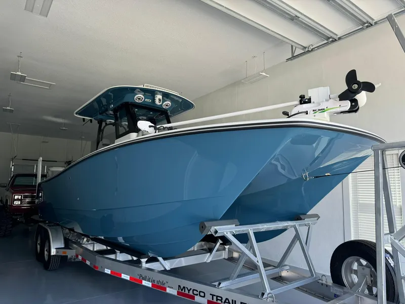Slide: The Image of 2024 Freeman 28 boat on trailer in garage, blue hull, modern design. - 10
